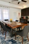 Live edge wood table adds an air of rustic elegance to the modern space